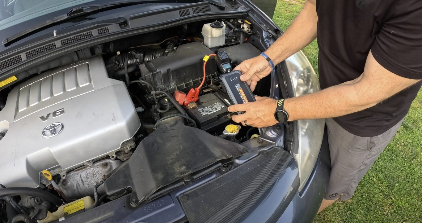 Trained roadside assistance professional providing battery service